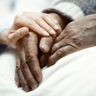 hand of woman touching senior man