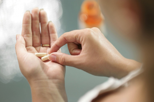 A woman in taking a tablet