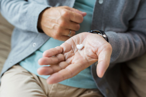 close up of senior man hand with heart shaped